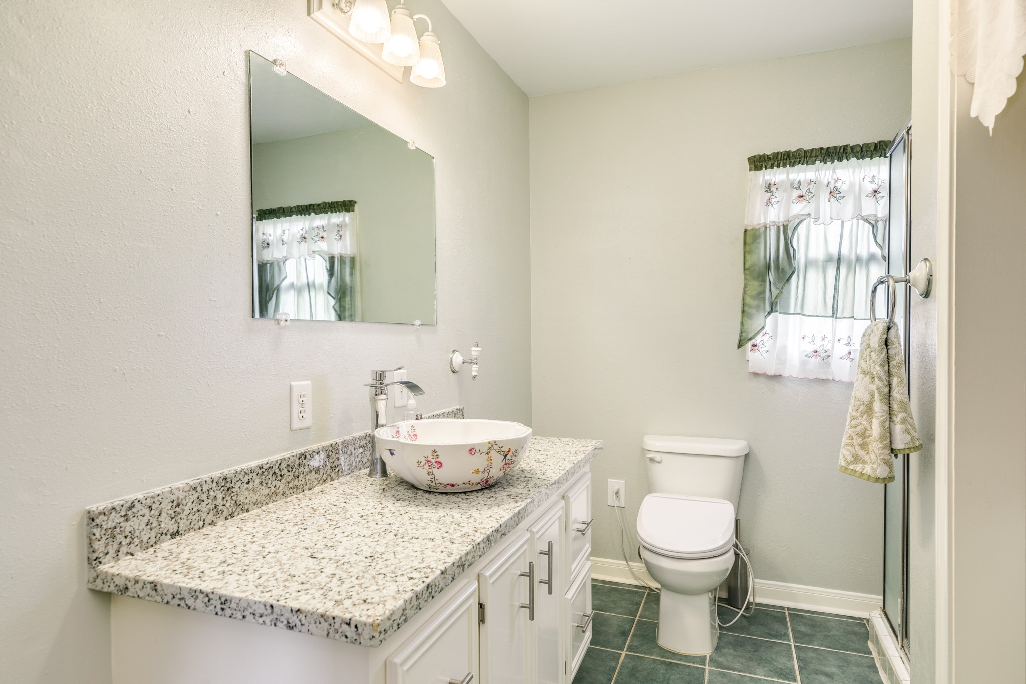 404 Chestnut Street Brazoria, TX 77422 - Photo 18 of 30 a bathroom with a granite countertop sink a toilet and a mirror