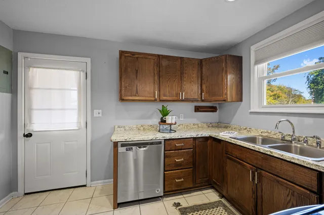 a kitchen with a sink stove and cabinets