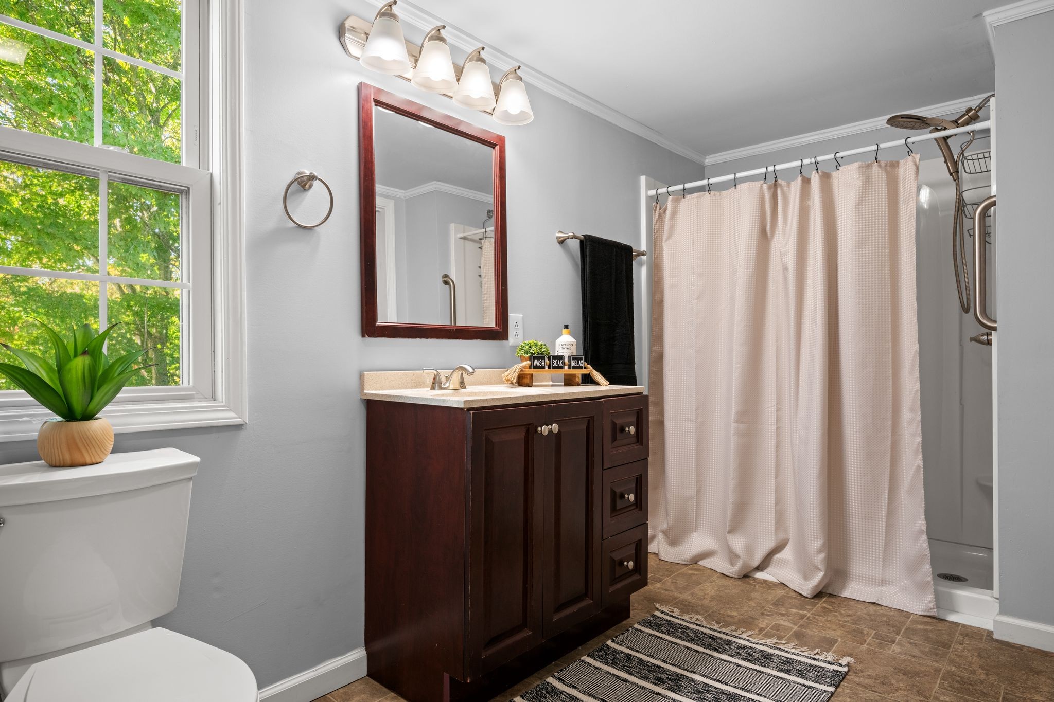 1105 Taylortown Road White Bluff, TN 37187 - Photo 18 of 27 a bathroom with a sink a mirror a toilet and a window