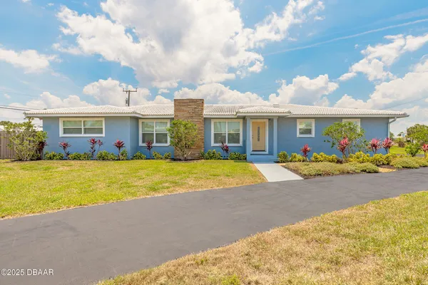 a view of house with swimming pool outdoor seating