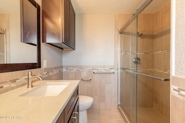 a bathroom with a sink toilet and shower
