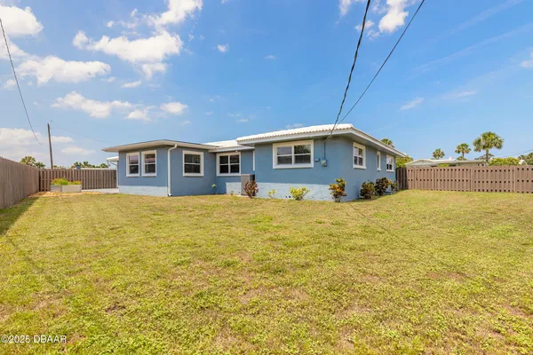 a blue swimming pool is next to a building