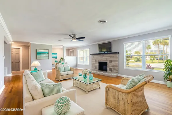 a living room with furniture fireplace and a large window
