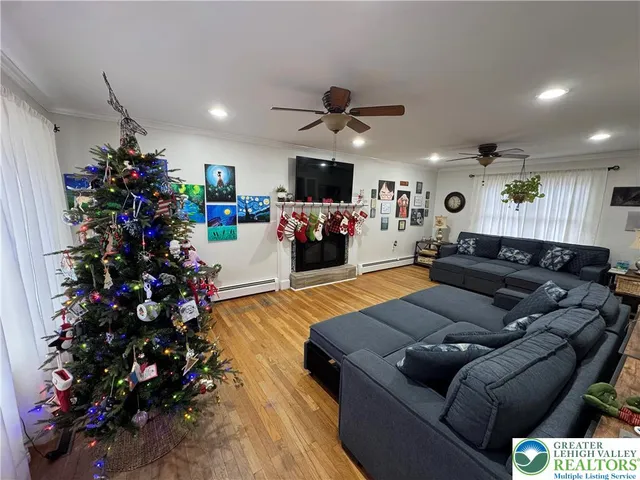 a living room with furniture flowers and a fireplace
