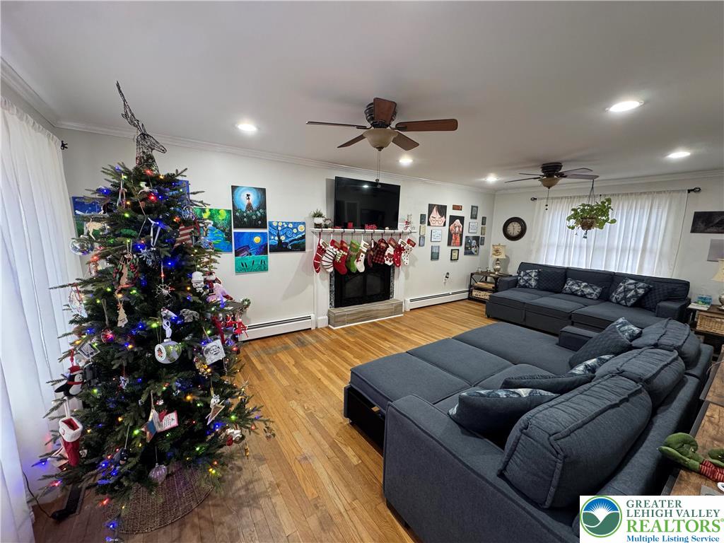 717 Liberty Street Emmaus, PA 18049 - Photo 13 of 35 a living room with furniture flowers and a fireplace
