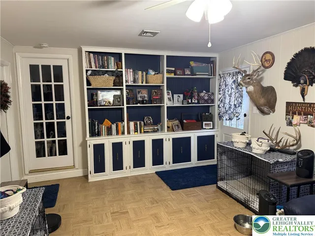 a living room with furniture cabinets and window