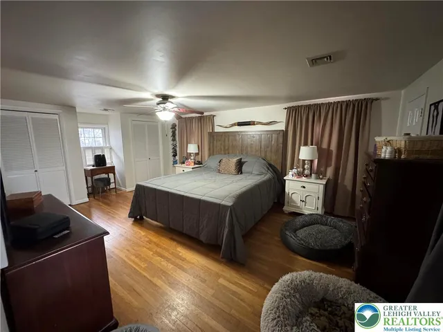 a bedroom with a bed window and a couch