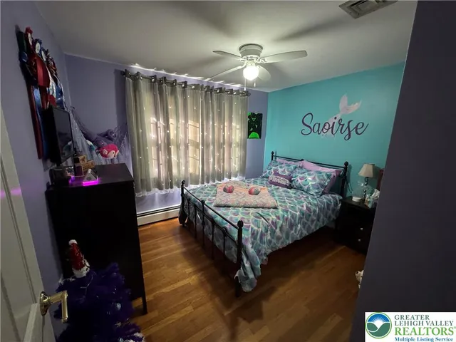 a bedroom with a bed dresser and a window