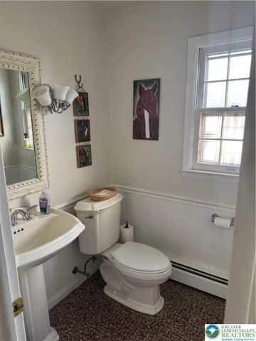 a white toilet sitting next to a bathroom sink