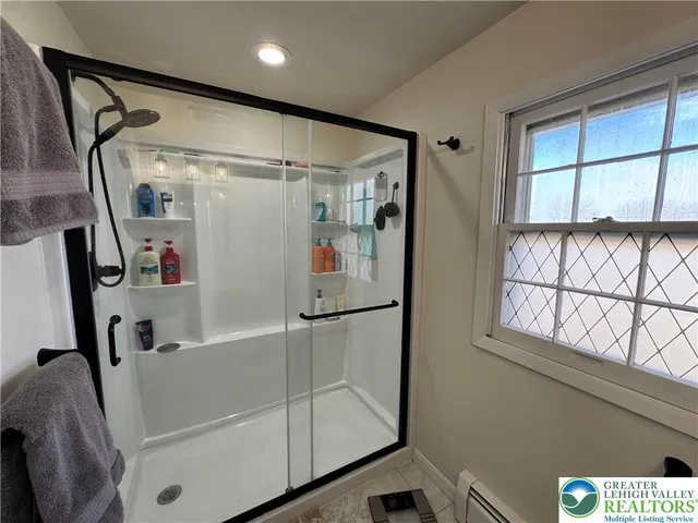 a bathroom with a bathtub and a shower