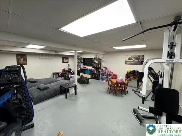 a living room with furniture and gym equipment