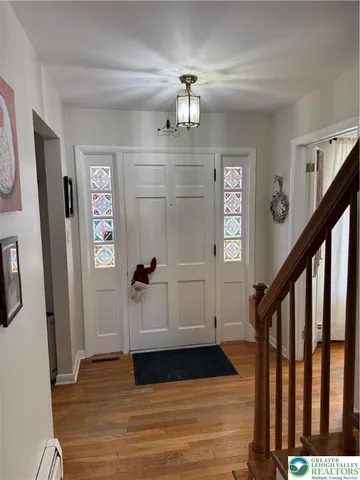a view of an entryway with wooden floor