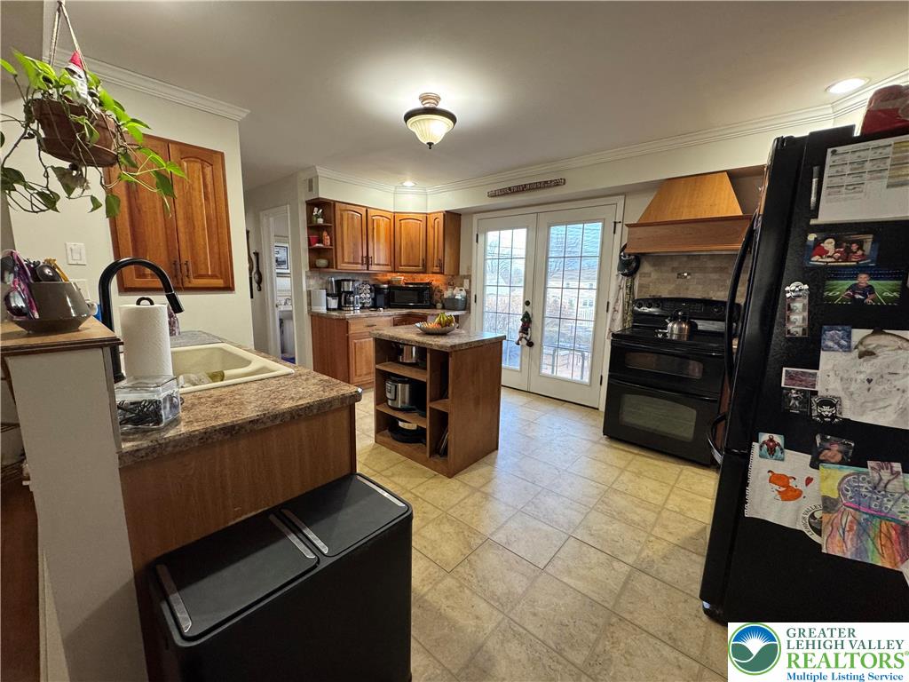 717 Liberty Street Emmaus, PA 18049 - Photo 8 of 35 a kitchen with stainless steel appliances kitchen island granite countertop a stove and a sink