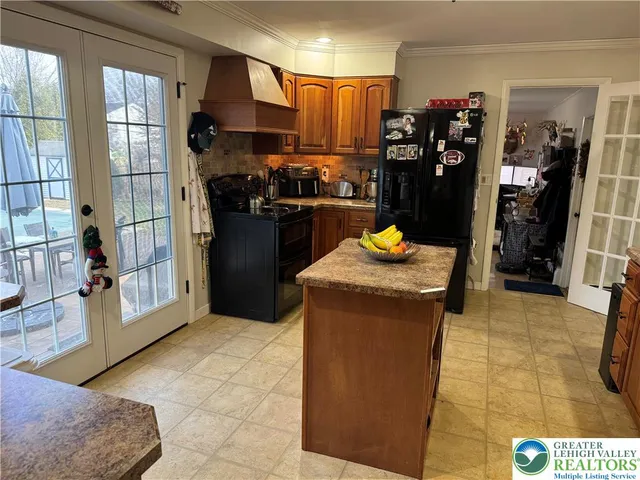 a kitchen with stainless steel appliances granite countertop a refrigerator and a sink