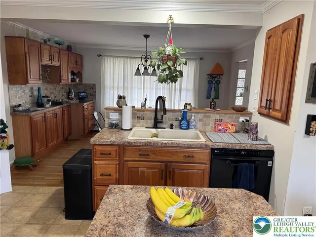a kitchen with a chandelier sink dining table and chairs