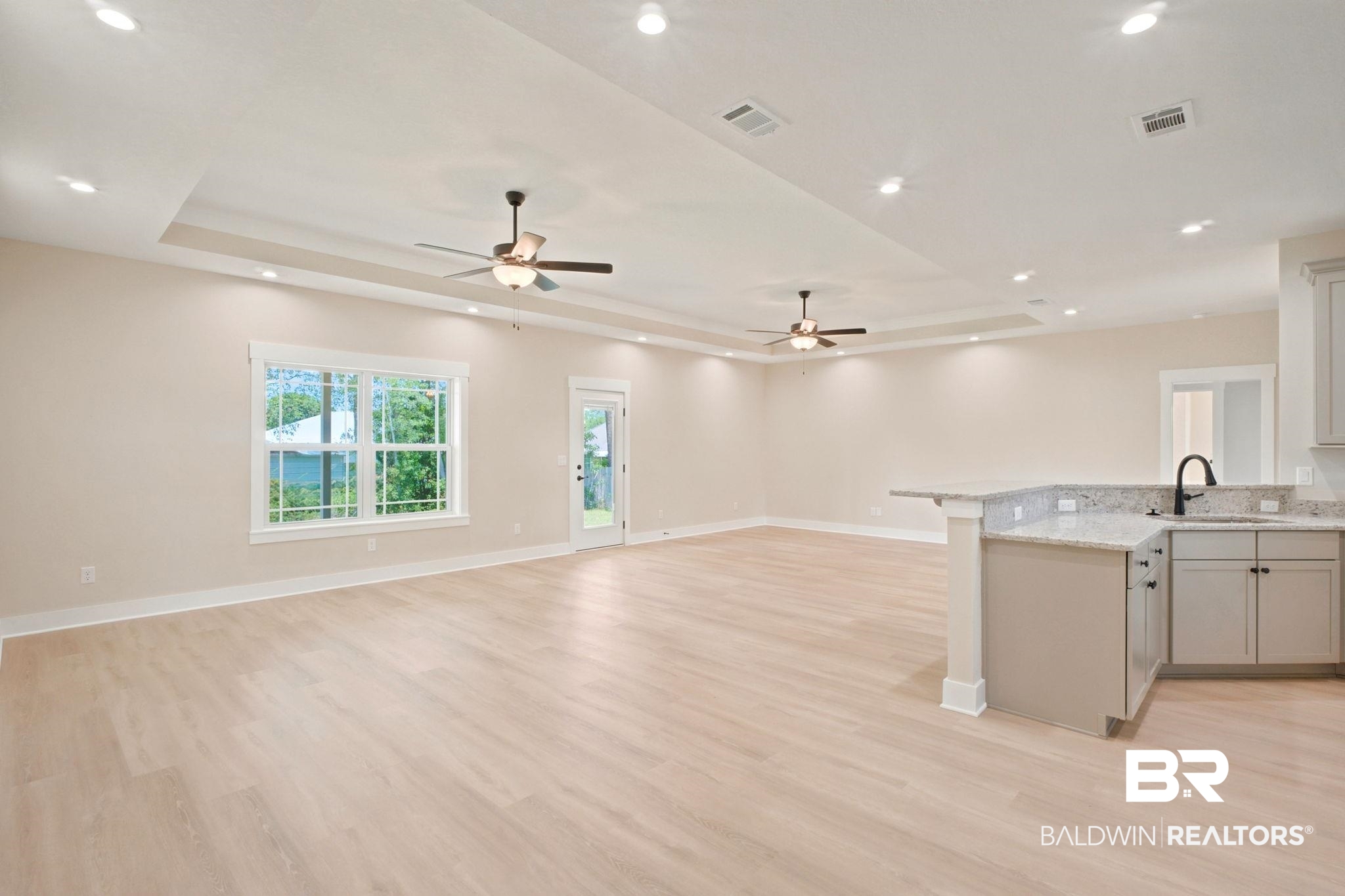 32656 Arbor Ridge Circle Lillian, AL 36549 - Photo 7 of 56 Spacious open-concept living area featuring light wood-finish flooring and neutral wall tones