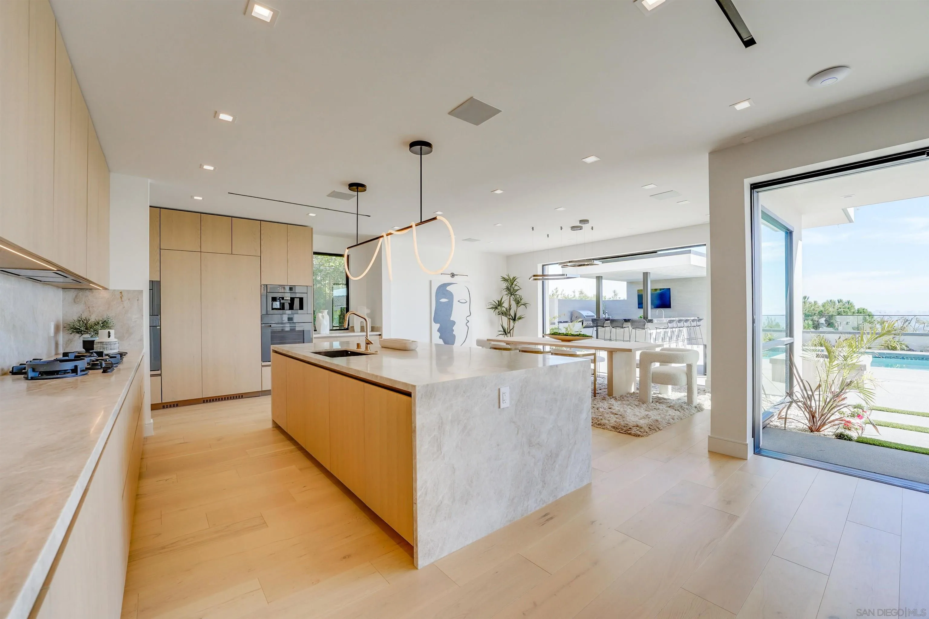 1205 La Jolla Rancho Road La Jolla, CA 92037 - Photo 24 of 75 a large kitchen with stainless steel appliances kitchen island granite countertop a large counter top and stove