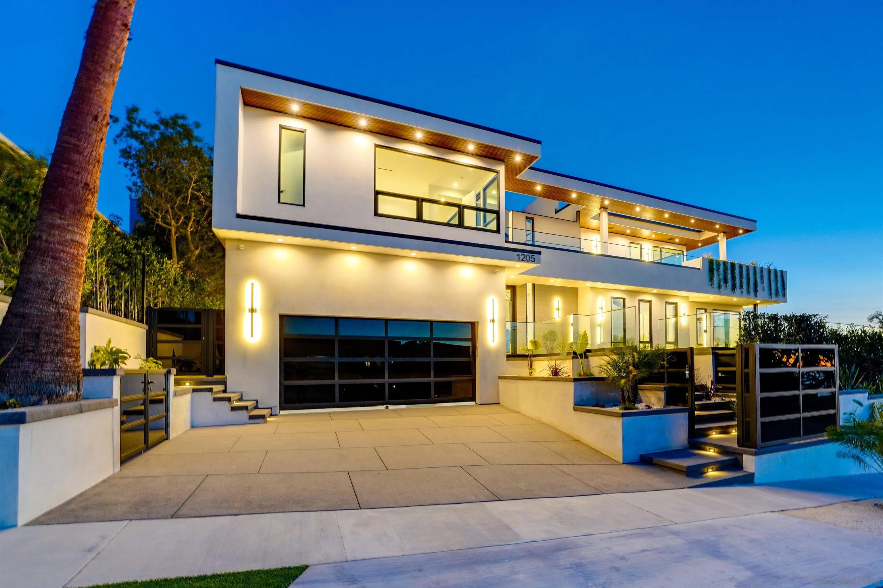 1205 La Jolla Rancho Road La Jolla, CA 92037 - Photo 3 of 75 a front view of a building with glass windows and garage