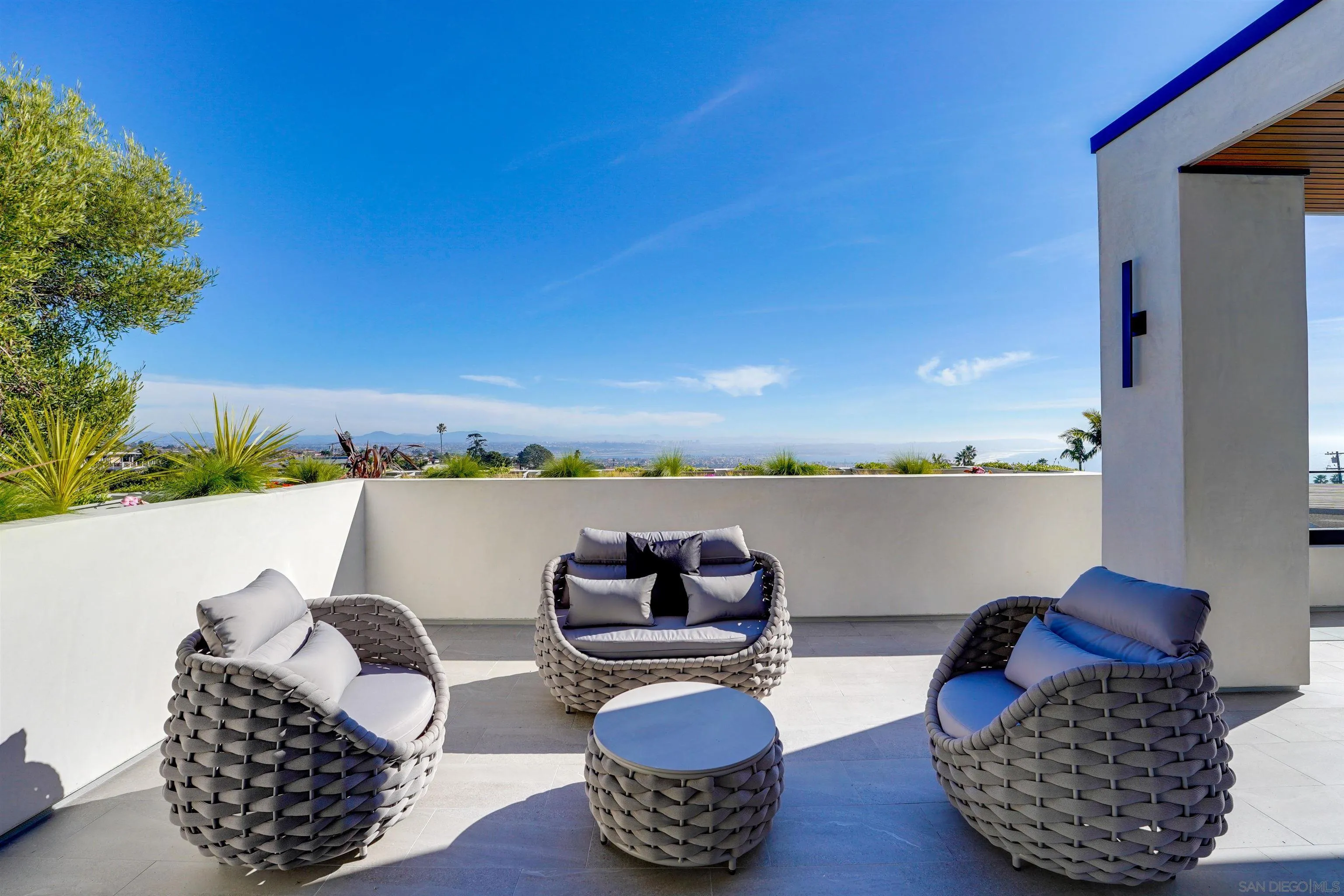 1205 La Jolla Rancho Road La Jolla, CA 92037 - Photo 36 of 75 a table and chairs sitting on a terrace with a lake view