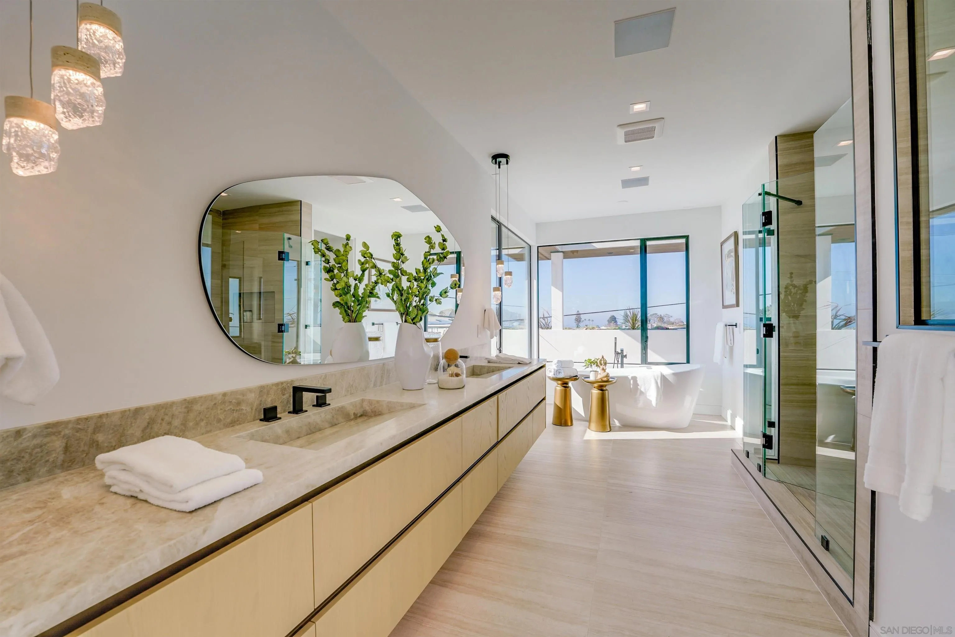 1205 La Jolla Rancho Road La Jolla, CA 92037 - Photo 40 of 75 a spacious bathroom with a granite countertop tub and a mirror