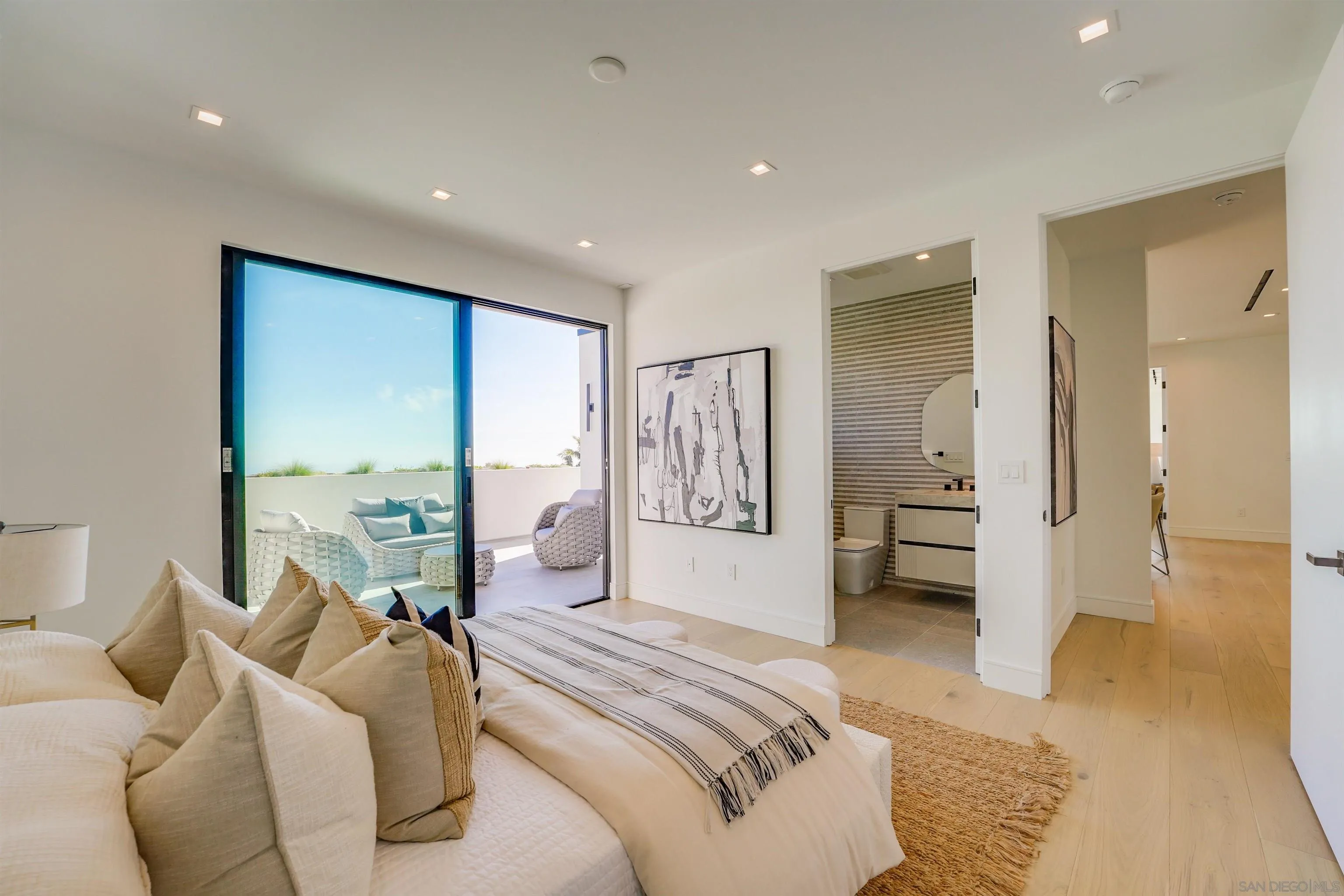 1205 La Jolla Rancho Road La Jolla, CA 92037 - Photo 44 of 75 a spacious bedroom with a large bed and a couch