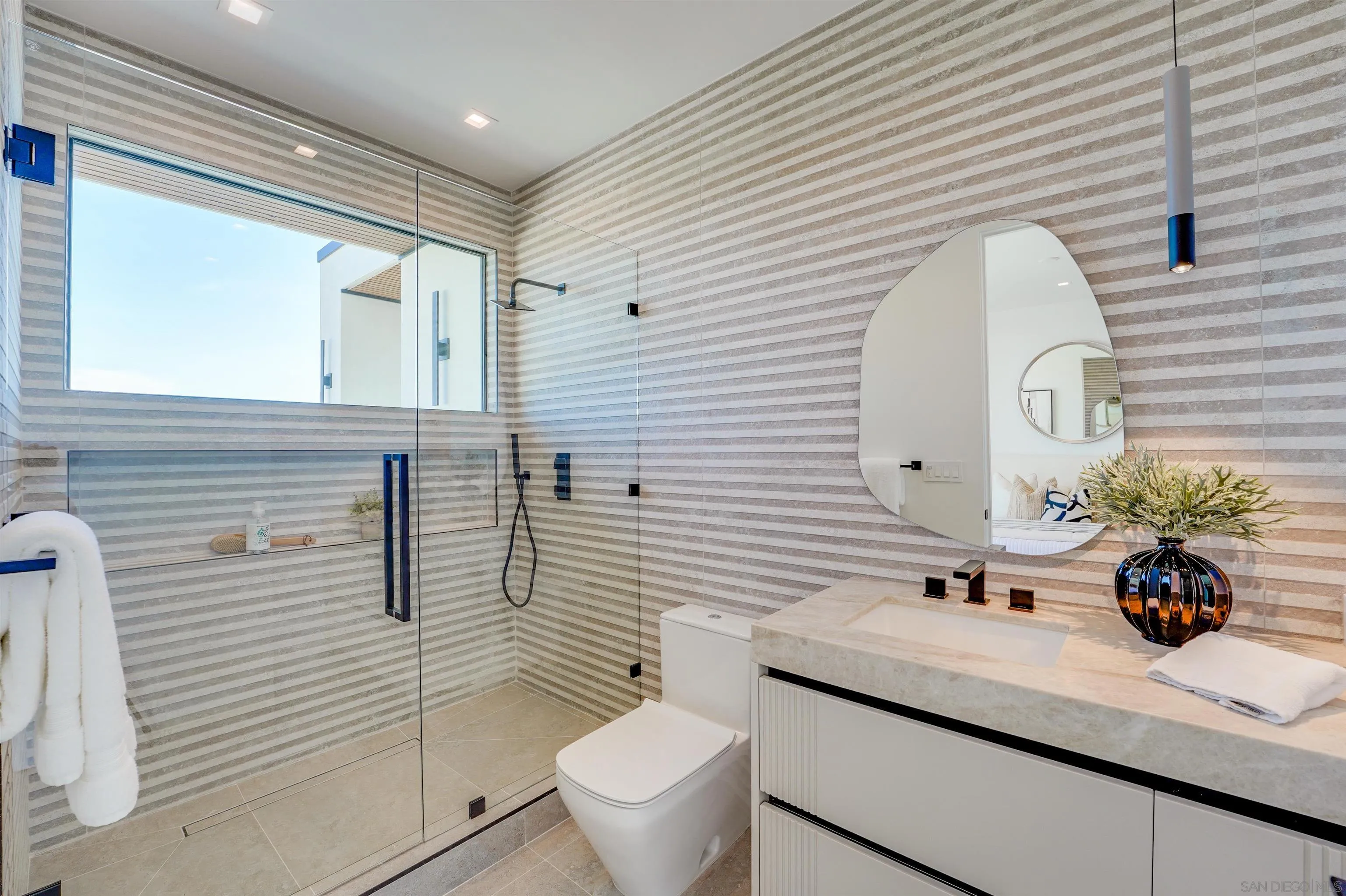 1205 La Jolla Rancho Road La Jolla, CA 92037 - Photo 45 of 75 a bathroom with a sink a toilet and mirror