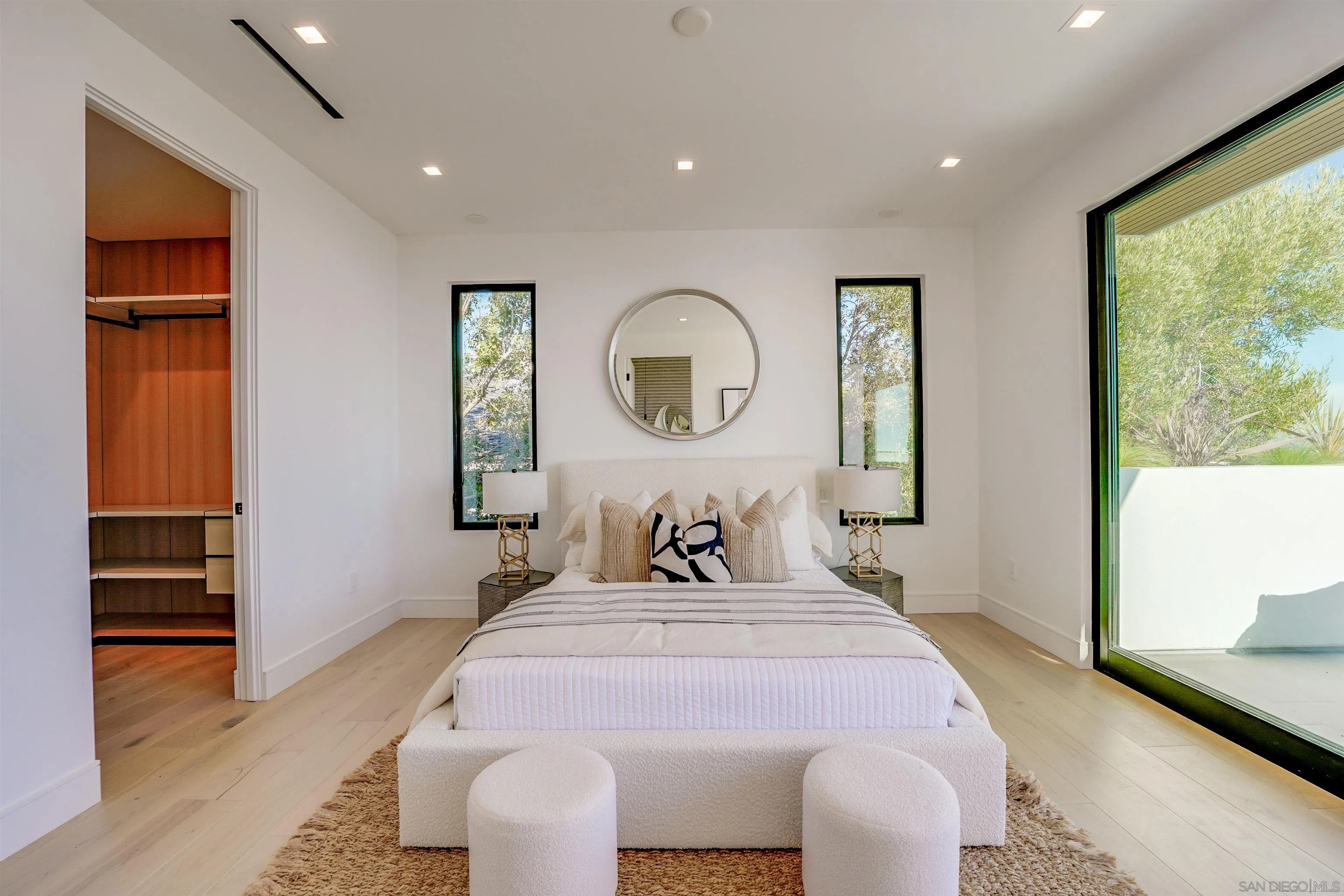 1205 La Jolla Rancho Road La Jolla, CA 92037 - Photo 46 of 75 a bedroom with a bed and a large mirror