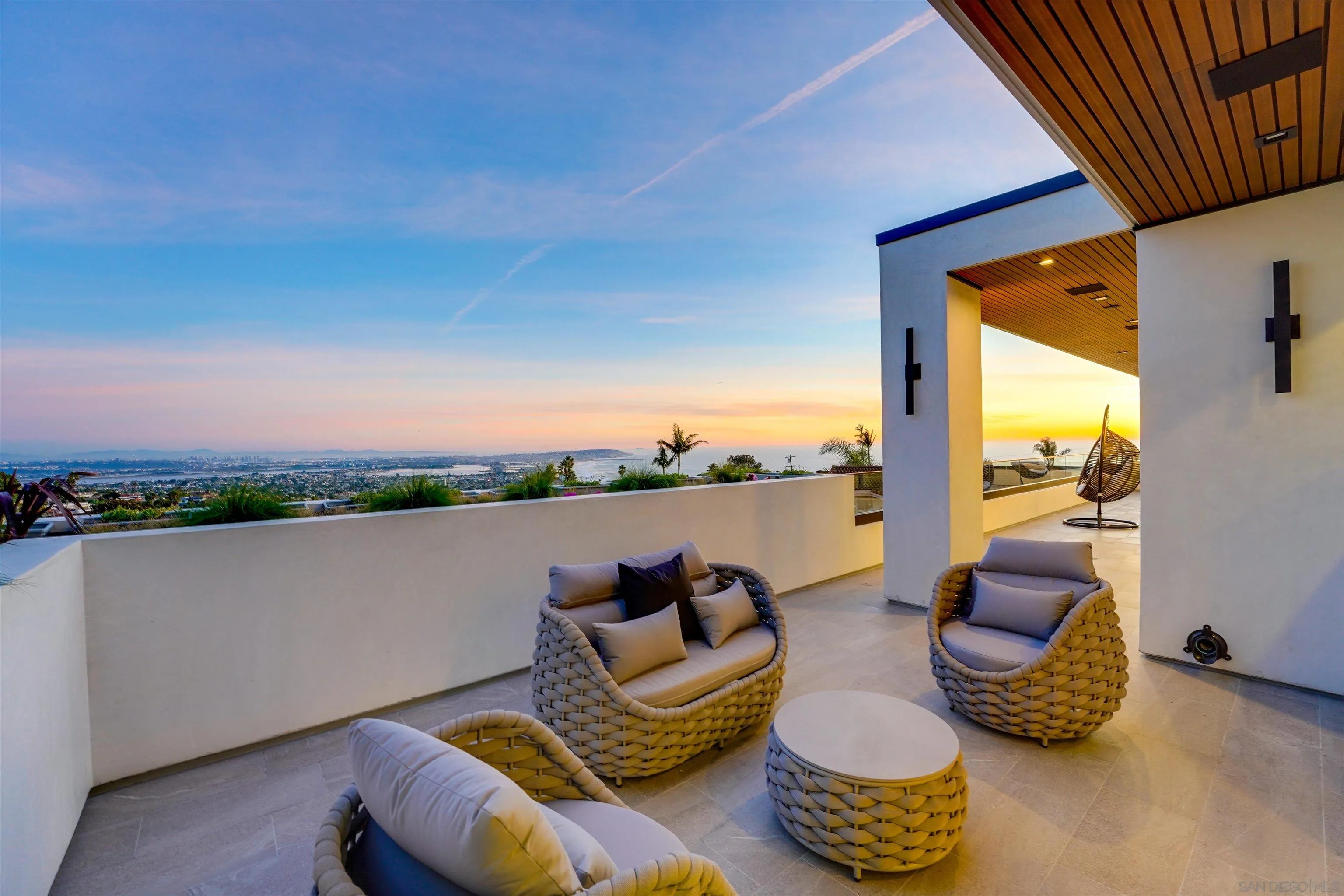 1205 La Jolla Rancho Road La Jolla, CA 92037 - Photo 66 of 75 a balcony with furniture and a floor to ceiling window