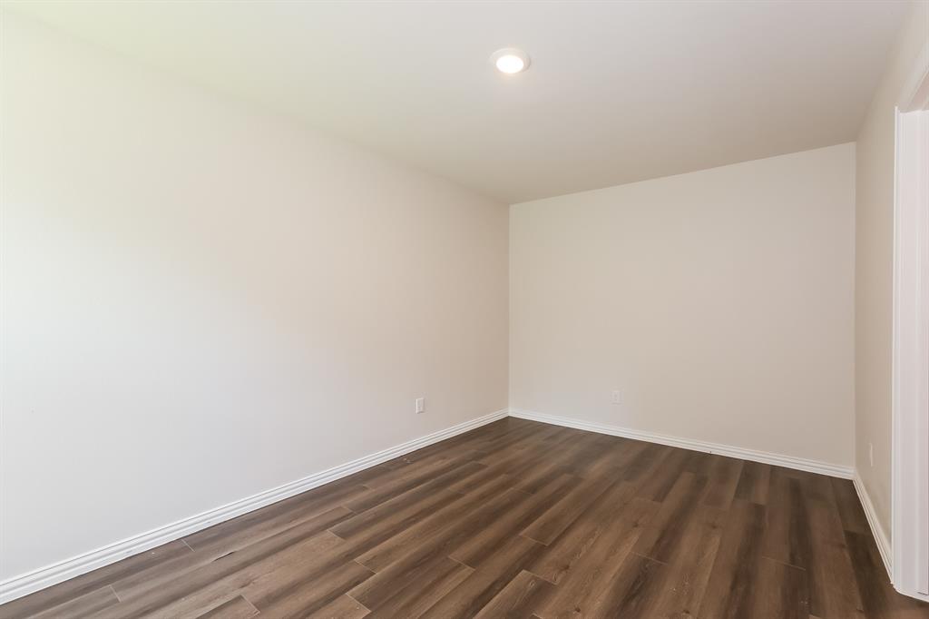 609 Sherman Street Waco, TX 76704 - Photo 12 of 21 a view of small space with wooden floor and white walls