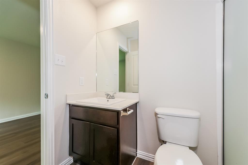 609 Sherman Street Waco, TX 76704 - Photo 13 of 21 a bathroom with a toilet a sink and mirror
