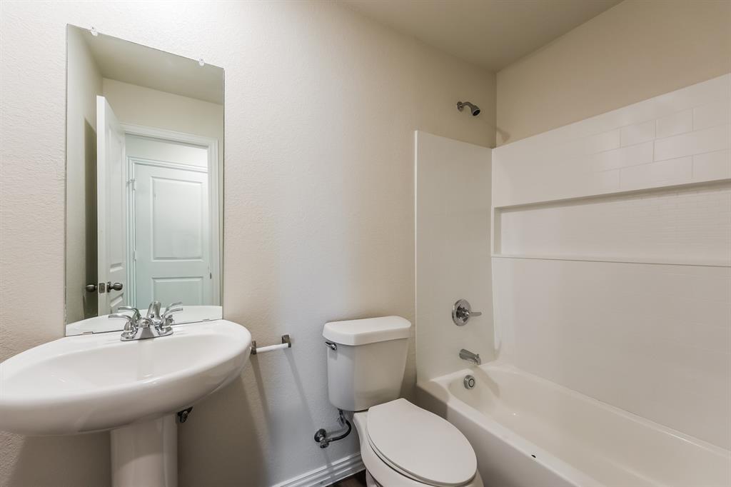 609 Sherman Street Waco, TX 76704 - Photo 16 of 21 a bathroom with a sink toilet and shower