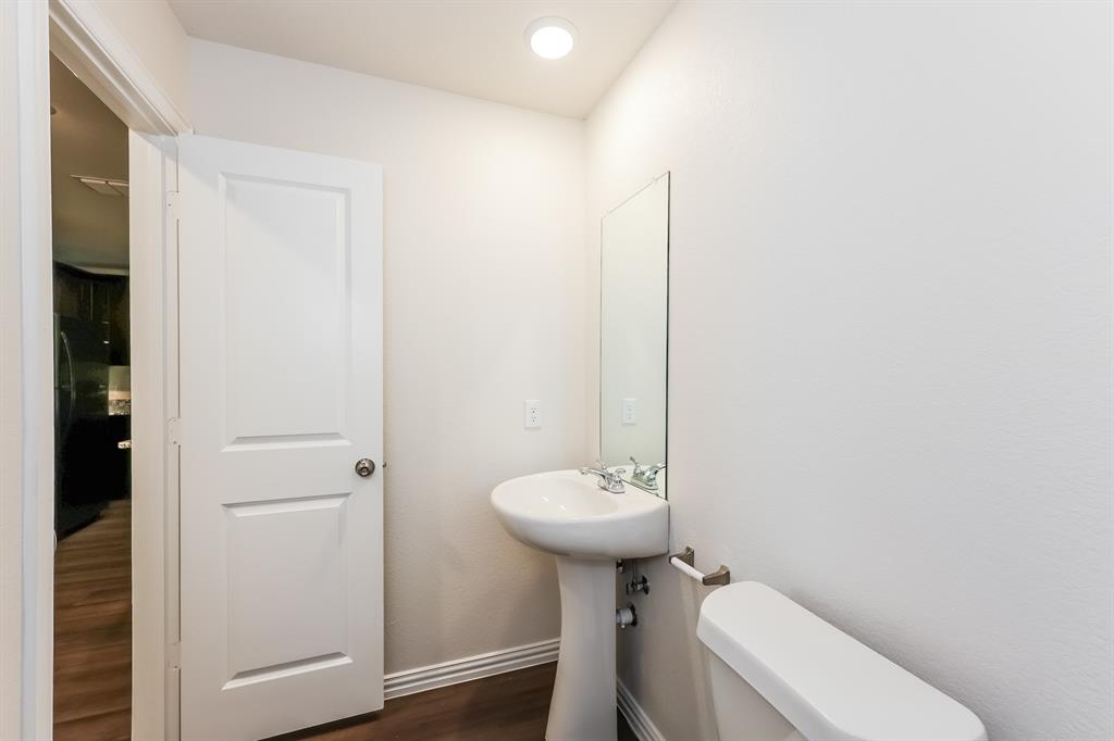 609 Sherman Street Waco, TX 76704 - Photo 17 of 21 a bathroom with a sink toilet and a mirror