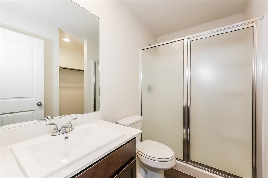 609 Sherman Street Waco, TX 76704 - Photo 18 of 21 a bathroom with a sink mirror vanity and toilet