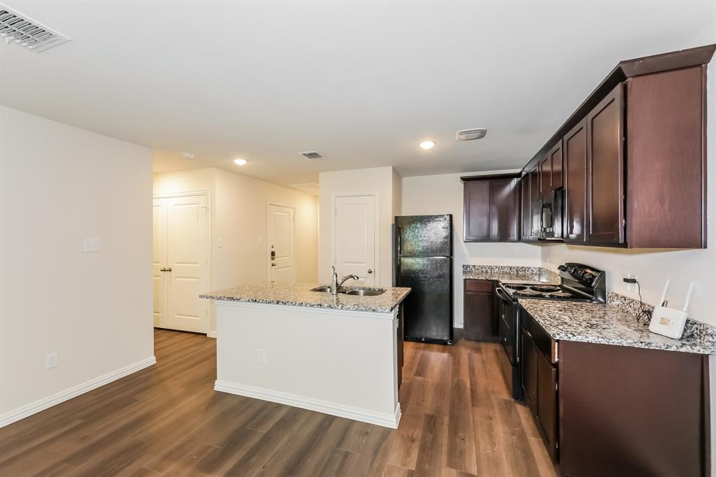 609 Sherman Street Waco, TX 76704 - Photo 5 of 21 a kitchen with stainless steel appliances granite countertop a sink stove and refrigerator