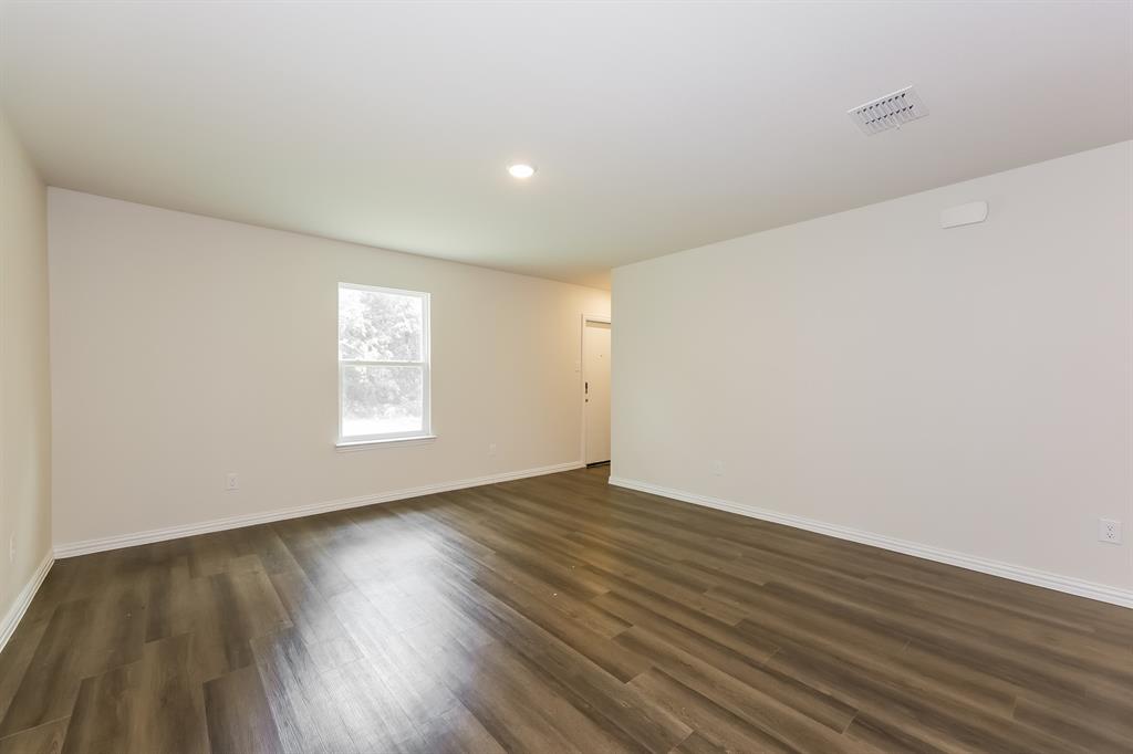 609 Sherman Street Waco, TX 76704 - Photo 7 of 21 a view of an empty room with wooden floor and a window