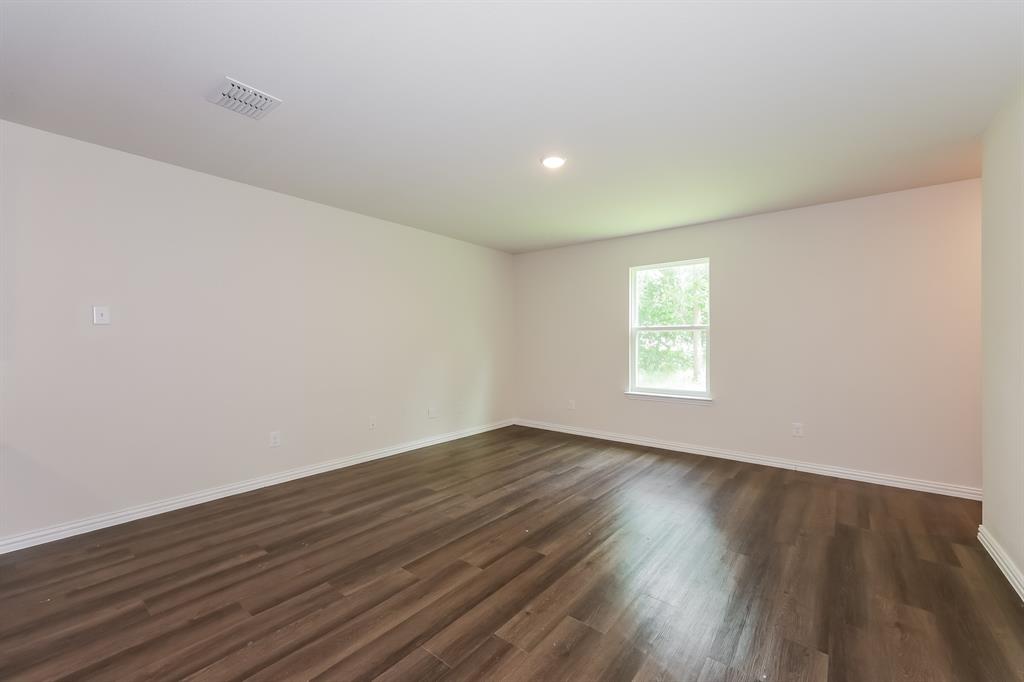 609 Sherman Street Waco, TX 76704 - Photo 8 of 21 a view of an empty room with wooden floor and a window