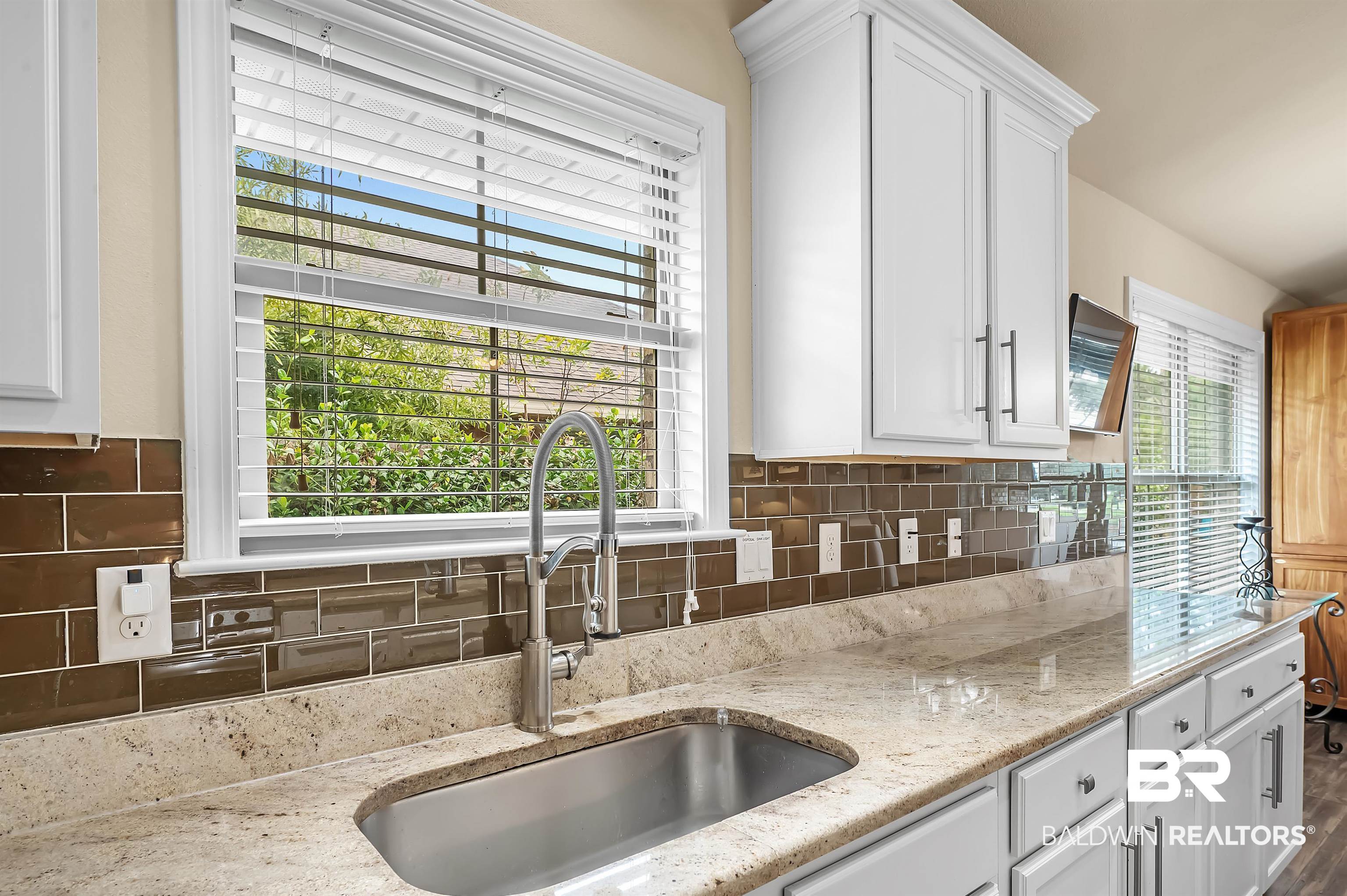 8896 Allay Lane Foley, AL 36535 - Photo 31 of 57 Kitchen with a wealth of natural light, sink, and white cabinets
