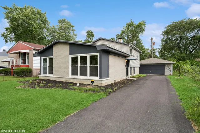 a front view of a house with a garden