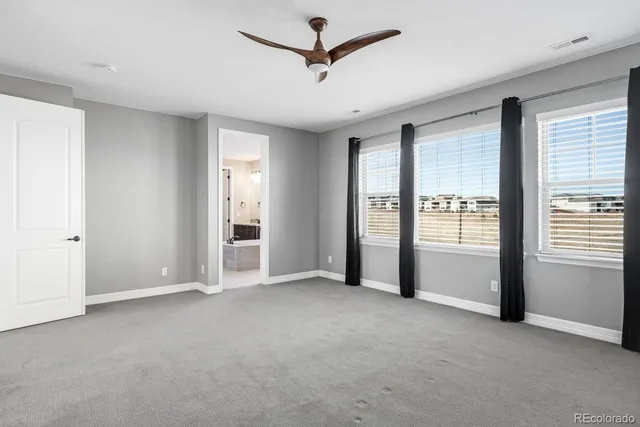 a view of empty room with a ceiling fan and window