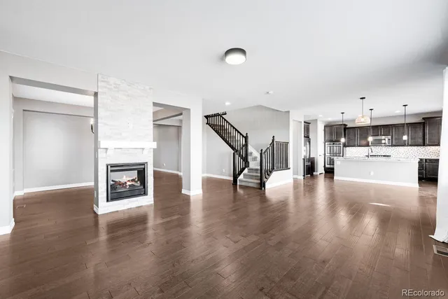 a view of a kitchen with furniture and wooden floor