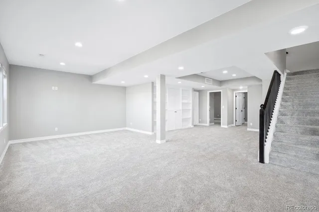 an empty room with large windows