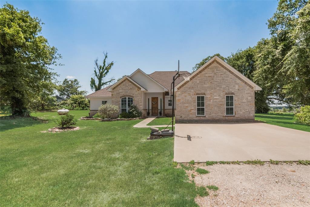 4320 Highway 198 Canton, TX 75103 - Photo 8 of 26 a front view of a house with a garden and yard