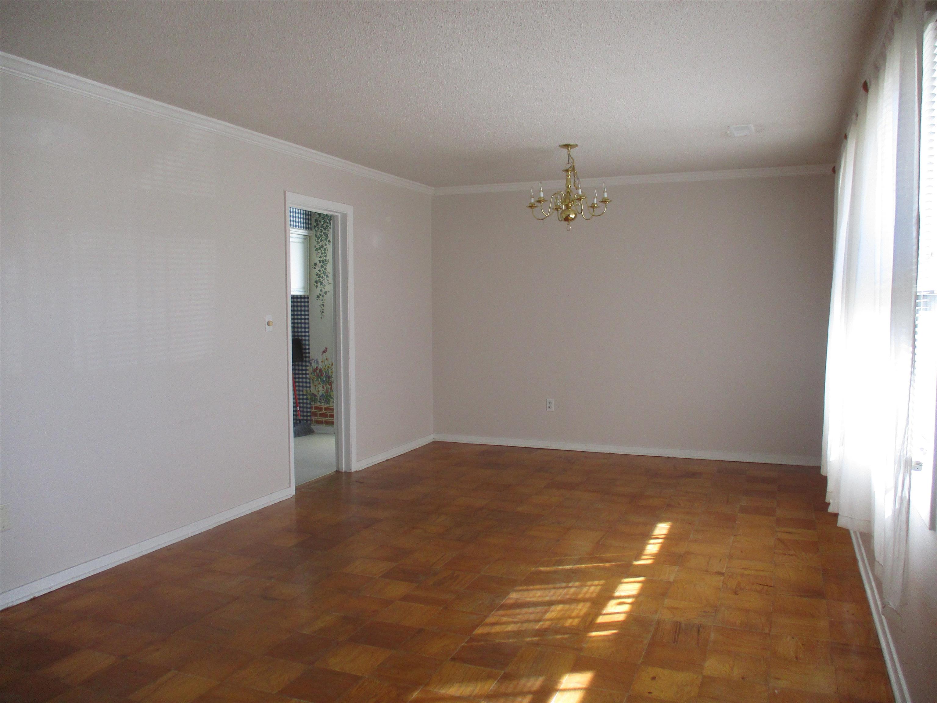 3752 Tea Rose Street, Unit 3752 Myrtle Beach, SC 29577 - Photo 6 of 8 Unfurnished room featuring a chandelier, crown molding, and a textured ceiling