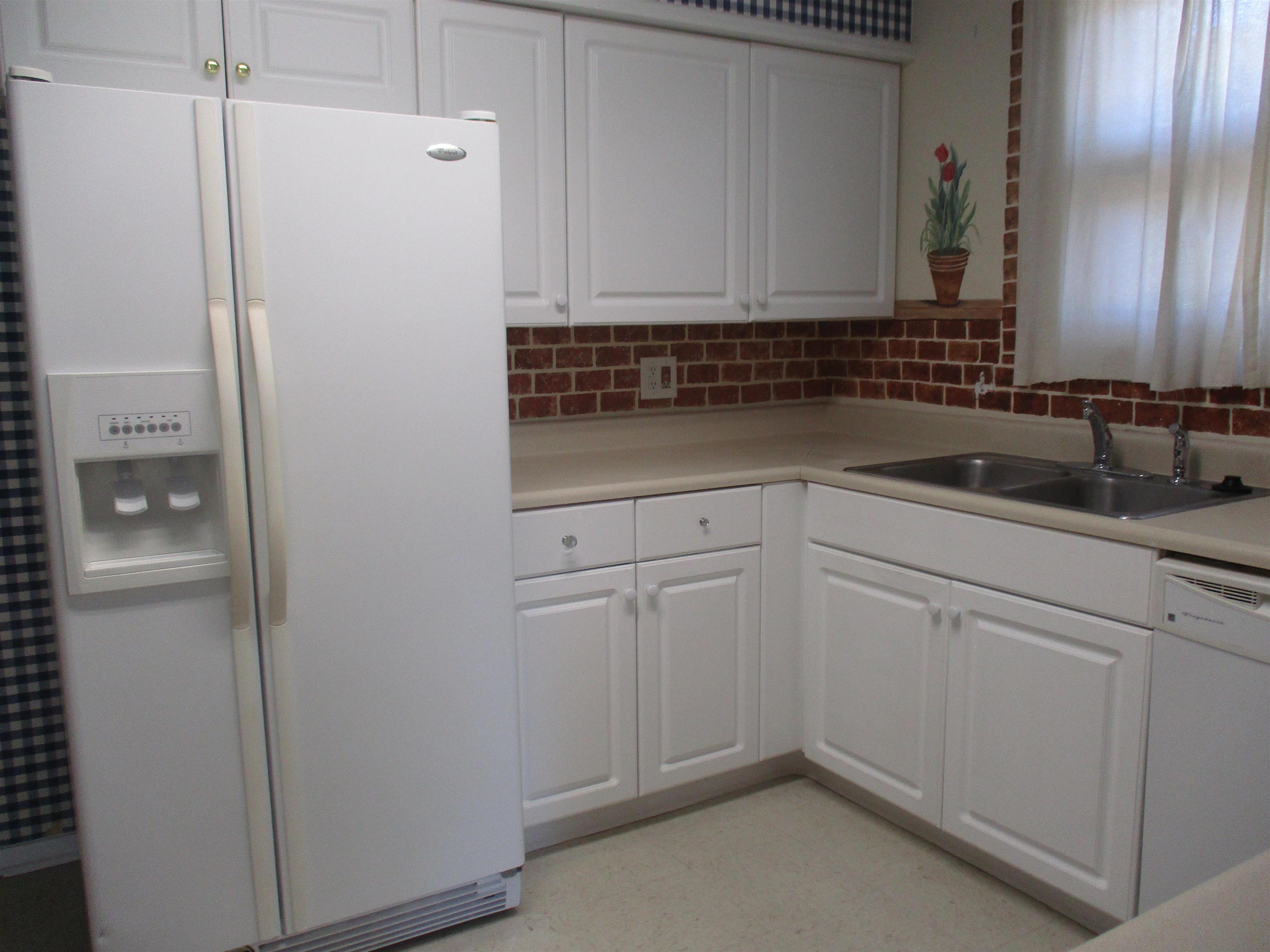 3752 Tea Rose Street, Unit 3752 Myrtle Beach, SC 29577 - Photo 7 of 8 Kitchen with white appliances, light countertops, white cabinetry, and light floors