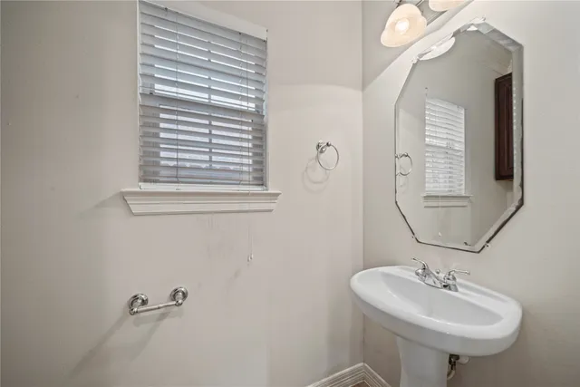 a bathroom with a sink a mirror and a window
