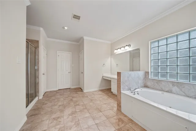 a bathroom with a bathtub and a shower