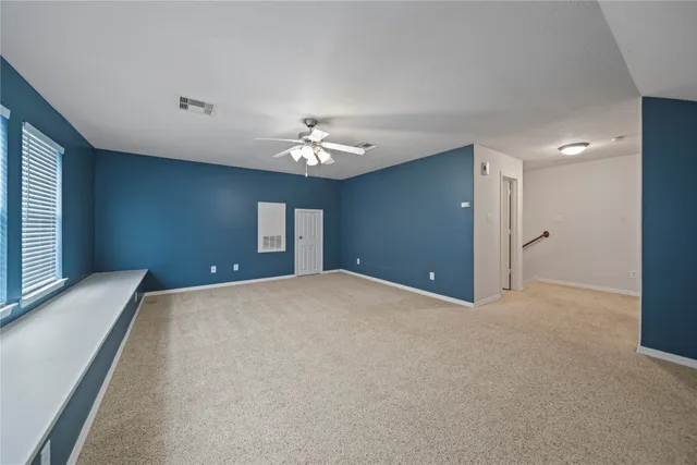 a view of an empty room with a chandelier