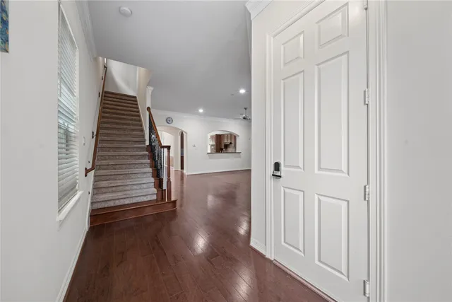 a view of a hallway with wooden floor and entryway