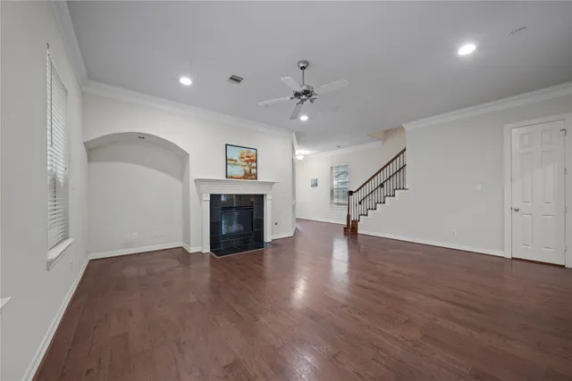 a view of empty room with wooden floor and fireplace