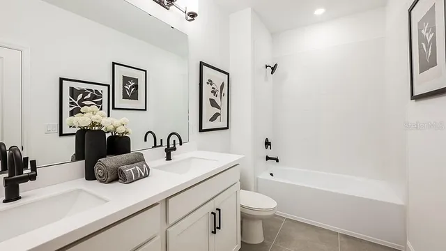 a bathroom with a double vanity sink mirror and shower